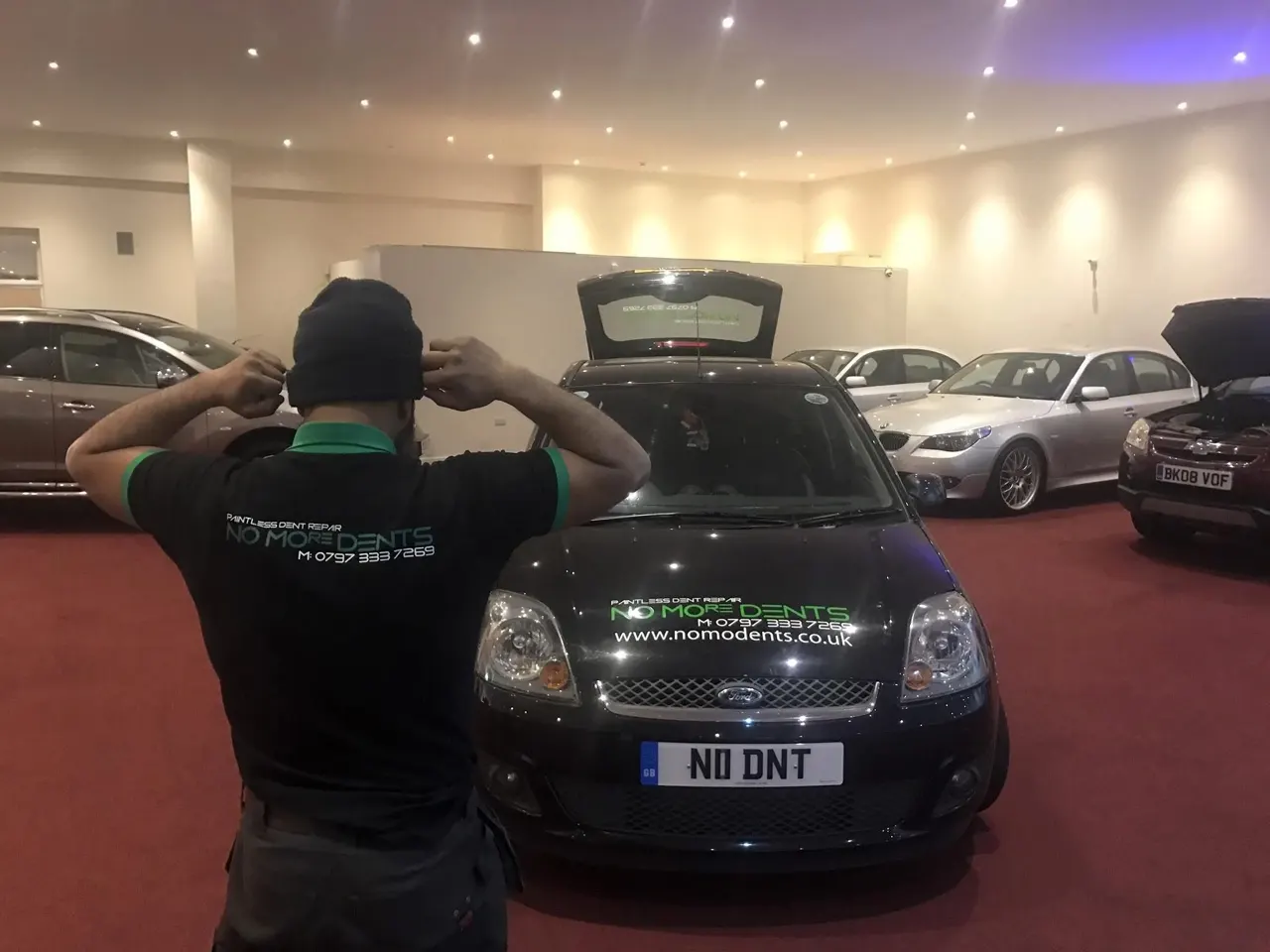 MO with the NoMoDents van at a car showroom